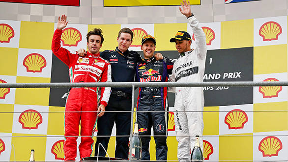 Fernando Alonso, Michael Manning---Red Bull's chief of trackside operations, Sebastian Vettel and Lewis Hamilton on the podium at Spa