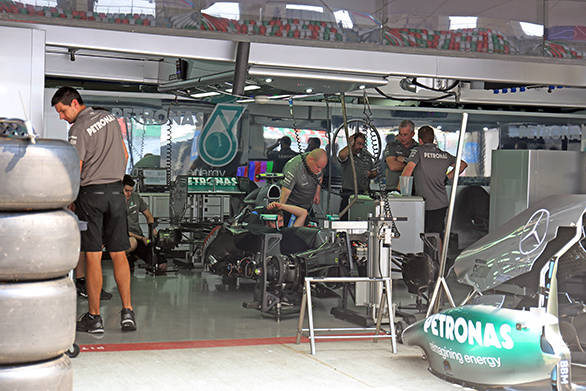 The Mercedes pits bustle with activity