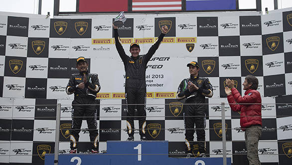 Race 2 winner and world champion Andrew Palmer flanked by Manabu Orido in second place and Frenchman Dimitri Enjalbert in third. Lamborghini CEO Stephan Winklemann applauds from below