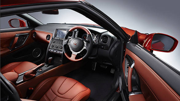 The steering wheel is wrapped in leather, while the aniline leather seats get stitched accents