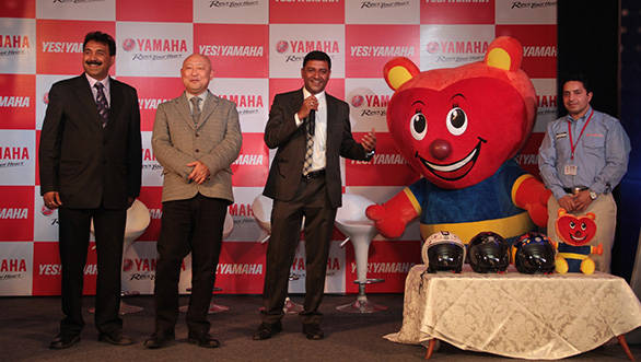 Yamaha India officials with the YCSP mascot and helmets