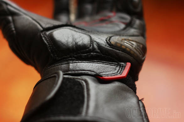 These gloves have a two-stage retension system - a velcro band (with the red tab) as well as bigger velcro flap