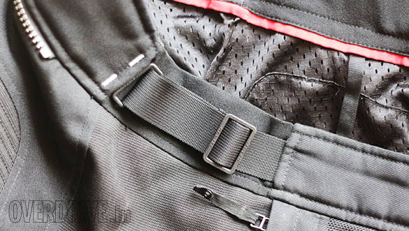 Most motorcycle pants accommodate a range of waist sizes to allow for good eating as well as layering in bad or cold weather. On this pair (Rev'it Airwave), the buckle slides to create more or less space. The black panel behind the webbing and buckle stretches