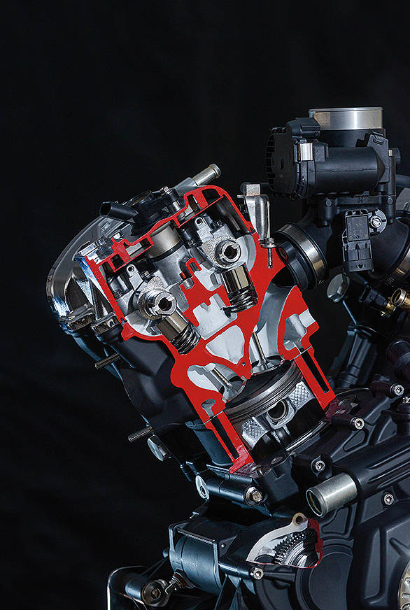 Here is a cutaway detail of the engine. You can clearly see the DOHC layout as well as two of the four valves above the piston. The engine is a relatively high compression unit at 9.5:1 by cruiser standards and boasts closed-loop fuel injection