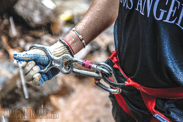 That metal figure of eight is what a descender is. The other two metal loops are the carabiners. They are all that is keeping you from falling.