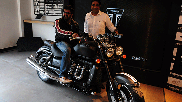 Vimal Sumbly, managing director of Triumph Motorcycles India with dealer Rishabh swinging a led over