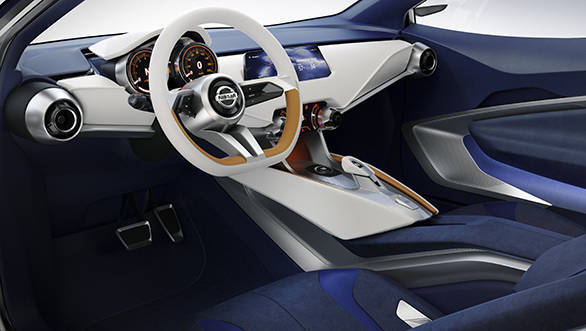 The interior uses a darker, deeper blue, with high contrasting ivory and orange colours matching the exterior to give a sense of unity to the car.