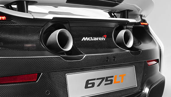 Two circular exhaust pipes, forged from titanium, exit centrally through exposed bodywork below the rear wing