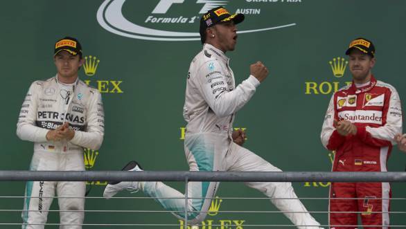 Lewis Hamilton celebrates his third world championship title at the United States GP as Nico Rosberg and Sebastian Vettel look on
