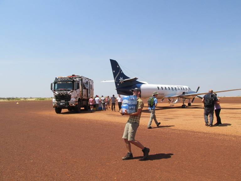 Our - Mother Ship - The 6 X 6 wheel drive truck getting re-stocked from a plane. Water also came in the plane and was the most vital thing in the bush.