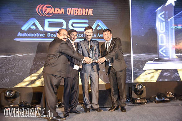 (L-R): John Paul, Vice President, FADA; Narain Karthikeyan, Formula One motor racing driver; Pankaj Dubey, Managing Director, Polaris India giving the dealer of the year for two-wheeler luxury category to Gallops Motors, KTM