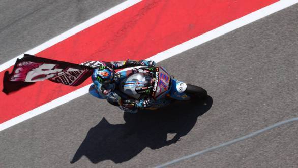 Aleix Espargaro carries a flag paying tribute to Luis Salom who died at Catalunya after a crash in Friday Free Practice