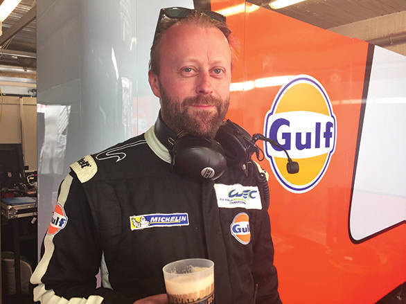 Owen Daley enjoys a much needed cold one after his team finished fifth in class at the 2016 24 Hours of Le Mans