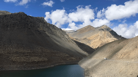 Suraj Taal is one of the two lakes you see before you come to the top of the Baralach La. Suraj Taal is also called Vishal Taal in the memory of a fallen Indian Army officer. On the right the vehicles are climbing up from the Army recovery camp at Patsio