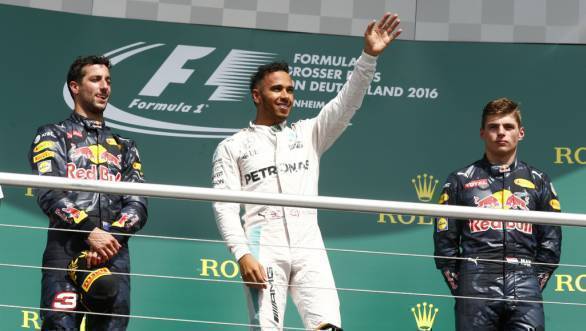 Victorious Lewis Hamilton on the podium at the 2016 German GP, flanked by Daniel Ricciardo and Max Verstappen