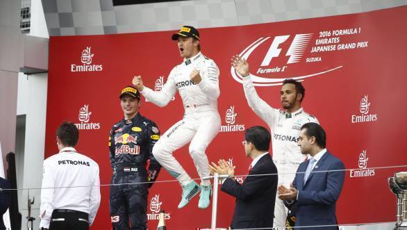 Nico Rosberg celebrates winning the 2016 Japanese Grand Prix, while second-placed Max Verstappen and third-placed Lewis Hamilton look on