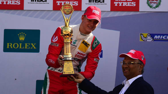 Mick Schumacher receiving the 1st place trophy from Mr