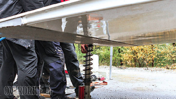 The Kahle Motorsport mechanics use the flatbed of a truck to help them load the springs