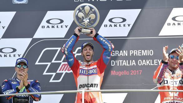Andrea Dovizioso celebrates victory at the Italian GP, as Maverick Vinales and Danilo Petrucci look on