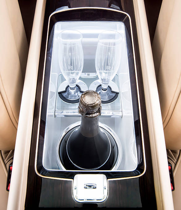 The entire centre console houses a mechanism that, at the touch of a button, deploys a bottle of the client's favourite champagne and two crystal champagne flutes