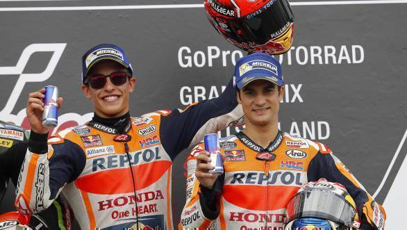 Marc Marquez celebrates on the podium with team-mate Dani Pedrosa who finished third at Sachsenring