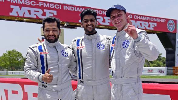Race 2 winner, Dhruv Mohite, flanked by Karminder Pal Singh and South African guest driver Devin Robertson