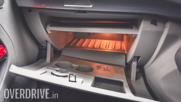 That glove box is big enough to hold a laptop (notice a separate compartment for it and is illuminated too). The tray can be removed to increase the storage capacity. The glovebox is cooled too