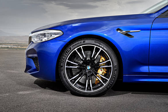 Behind those light-metal cast dual-spoke bicolour wheels are the gold calipers that identify the optional carbon ceramic brakes