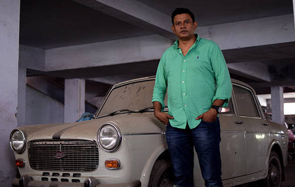 Mohammad Omar and his uncle's 1996 Padmini, now parked in an unlit basement